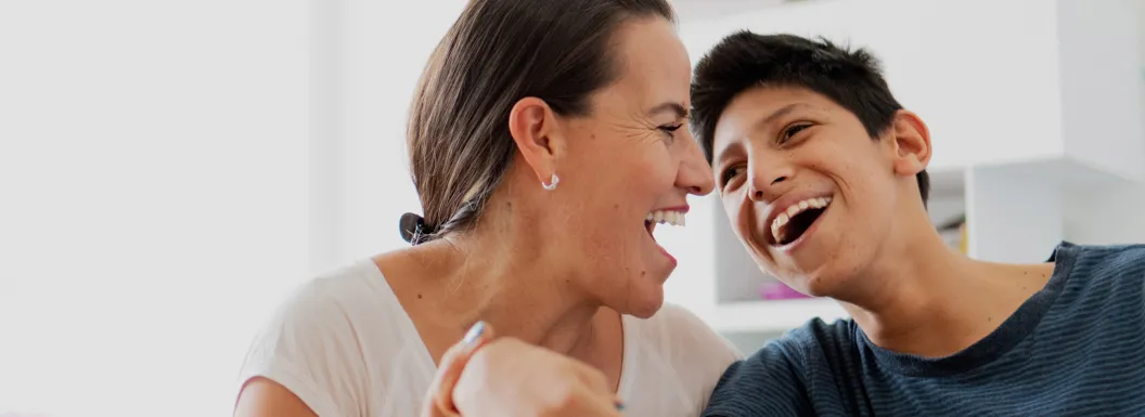 Woman and young boy smiling and laughing
