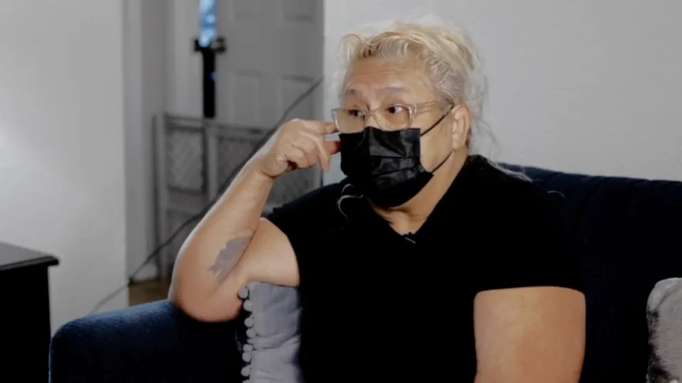 Home Assist Health employee sitting and wearing a black medical mask